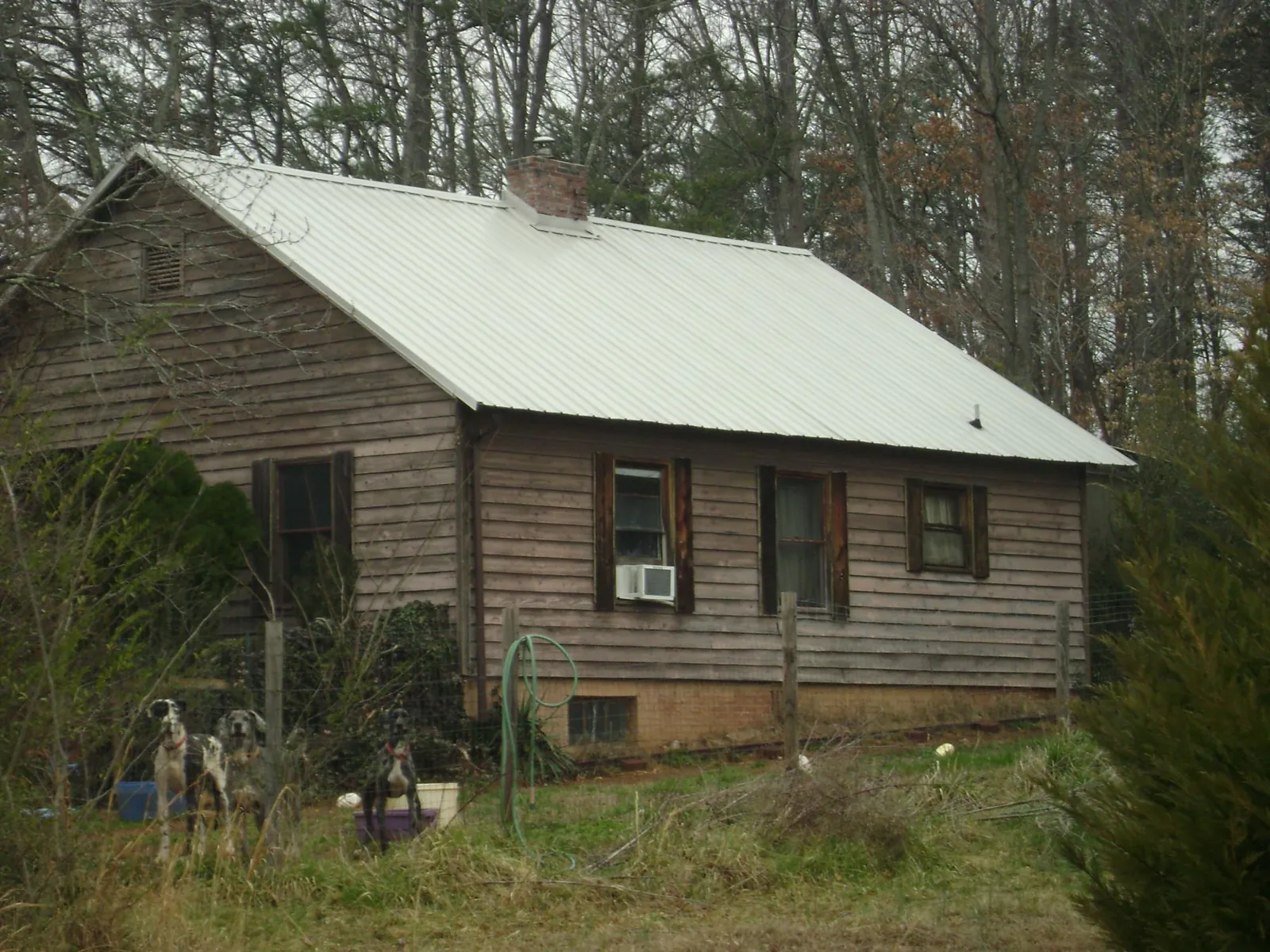 White metal roof on an old wood sided farmhouse, from a Metal Roof Installation job in Lebanon